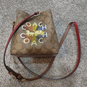 Coach Brown Crossbody Bag with Red Strap